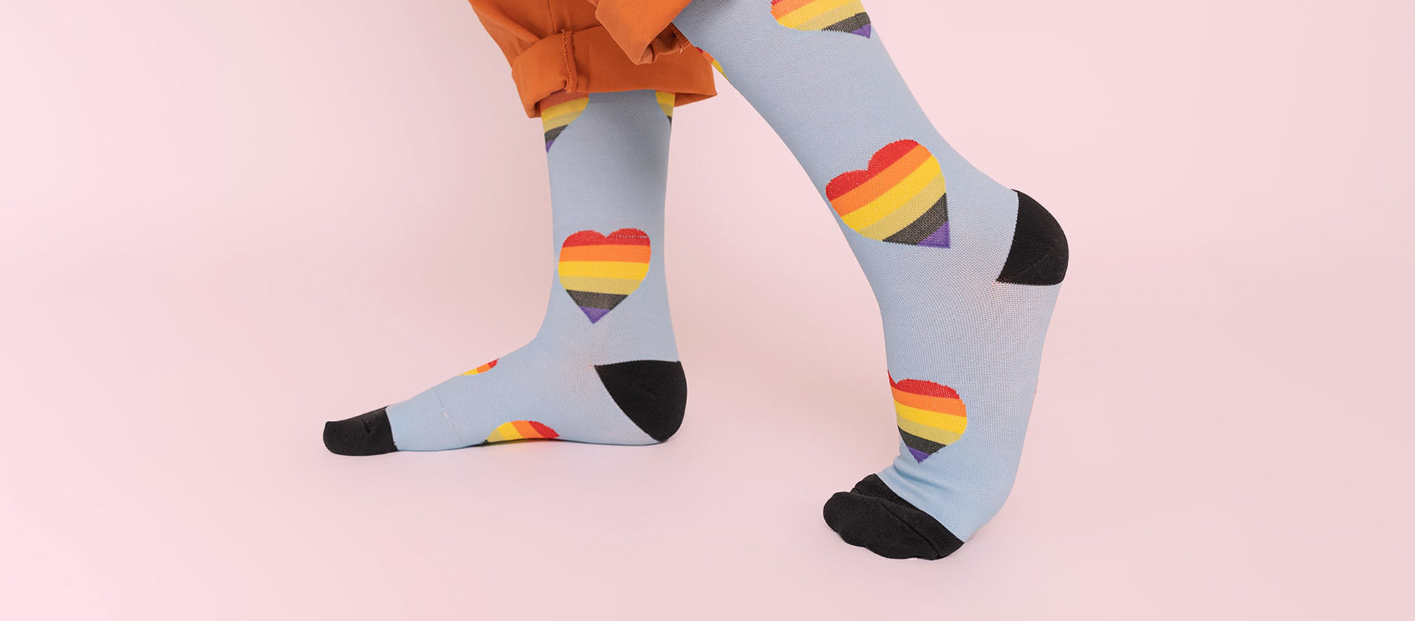 Nursely rainbow heart socks on pink background